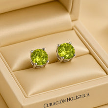 .	Natural peridot stud earrings on cream satin jewelry box