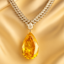 Close-up of faceted citrine teardrop pendant with white quartz detail”