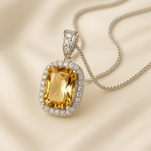 Handmade citrine and white quartz pendant necklace on satin display