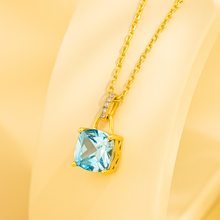 Aquamarine and gold chain necklace under studio lighting