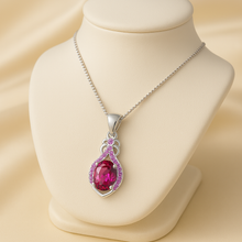 “Boho style ruby necklace with intricate pink gemstone halo design.”