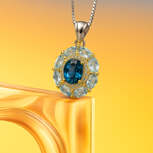 Close-up of sterling silver and gold plated pendant with topaz center