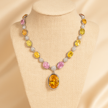 	Elegant morganite and silver necklace worn with classic white blouse.