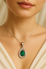 .	Emerald teardrop necklace worn on neckline for size reference