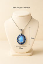 “Elegant handmade necklace featuring genuine opal and sapphires, crafted for emotional healing and unique beauty.”