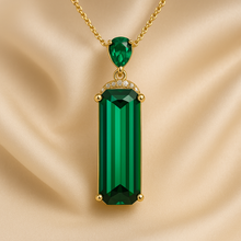 “Luxury handmade Nano Emerald statement necklace by Curación Holística on satin cream background, sterling silver with gold finish, boho elegant style.”