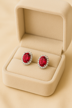 Boho chic ruby statement earrings reflecting vibrant red and brilliant sparkle.”