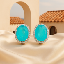 Front-facing view of handcrafted Paraiba tourmaline earrings