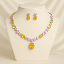 Multi-gemstone necklace set on cream satin background with earrings displayed.