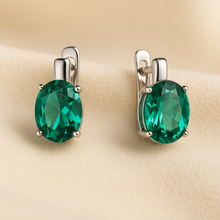 Handmade nano-emerald sterling silver earrings on cream satin background