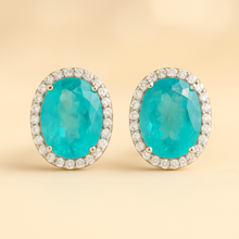 	Front-facing view of handcrafted Paraiba tourmaline earrings