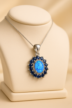 “Close-up of Curación Holística’s exclusive opal and sapphire pendant, designed for soulful luxury.”