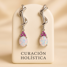 “Close-up of sculptural opal and ruby drop earrings in luxury finish”