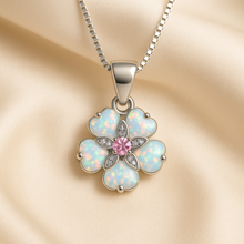 “Imagine a soft sunrise woven into a bloom of precious stones—each opal petal catching the first light of morning, while a tender rose quartz heart hums quietly at its center. With this necklace, you don’t just wear jewelry; you wear a promise of beauty, love, and renewal crafted by hand, and kissed by the spirit of Curación Holística.”