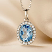 .	Close-up of oval aquamarine pendant with white quartz accents
