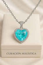 “Curación Holística exclusive heart-shaped Paraiba Tourmaline sterling silver statement necklace on a satin background – vibrant electric blue gemstone surrounded by pavé-set crystals.”
