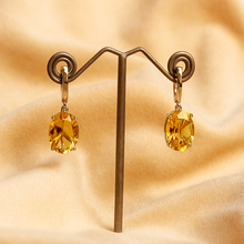 Sterling silver earrings featuring vibrant oval-cut citrines