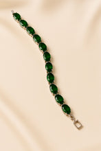 Luxury emerald bracelet close-up showcasing prong setting detail.