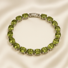 .	Handmade peridot gemstone tennis bracelet on cream box
