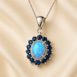 “Handmade opal and sapphire halo necklace set in sterling silver, radiating healing energy and timeless elegance.”