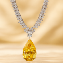 Close-up of faceted citrine teardrop pendant with white quartz detail”