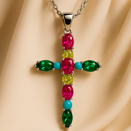 “Handmade multi-gemstone cross necklace on luxury satin display”