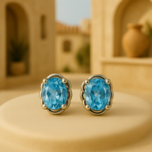 	•	Elegant oval aquamarine gemstone earrings with silver floral setting