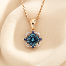 Dainty sapphire and topaz jewelry piece with gold accents