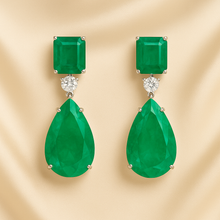 Close-up of sterling silver earrings with green nano emerald and white quartz stones