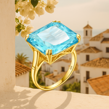 Close-up of large Aquamarine statement ring in gold setting.