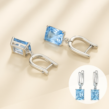 	Earrings displayed on a satin backdrop (luxury aesthetic)