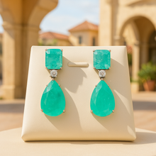 	Elegant tourmaline drop earrings against neutral background