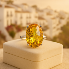 “Artisan at work hand-setting a natural citrine into a sterling-silver mount.