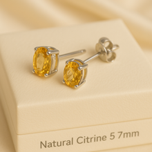 Natural citrine stud earrings in sterling silver on cream jewelry box