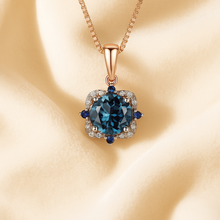 Close-up of London topaz and sapphire necklace on cream background