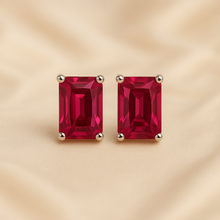 Curación Holística ruby earrings with satin background and studio lighting