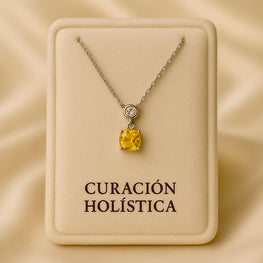 “Small cushion-cut citrine and white quartz pendant necklace in sterling silver by Curación Holística, displayed on soft cream velvet with luxury studio lighting.”
