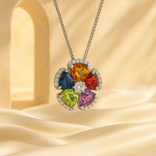 “Close-up of handmade sterling silver floral necklace with multicolored gemstones”