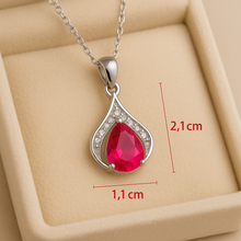 “Side view of ruby and white quartz pendant showing intricate artisan detailing.”