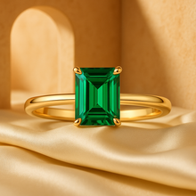 Emerald-cut green gemstone ring with minimalist gold design