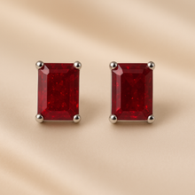 Red ruby silver stud earrings close-up