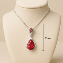 Close-up of handcrafted ruby teardrop jewelry with vibrant red gemstone