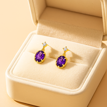 	“Luxury close-up of earrings showing gold detailing and faceted stones”