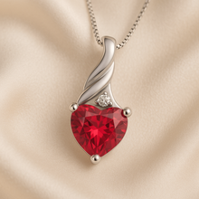 	Side angle view of radiant ruby heart necklace with Spanish architecture backdrop