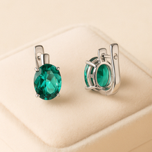 Artisan-crafted sterling silver earrings featuring oval nano-emeralds