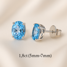 	•	Elegant Woman Wearing Minimalist Aquamarine Earrings
