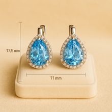 Measurement overlay showing exact size of aquamarine stones
