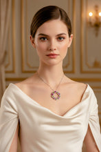Woman wearing a necklace with a decorative pendant in an elegant setting
