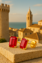 “Hand holding ruby rose earrings highlighting gemstone sparkle and gold setting.”
