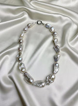 Pearl necklace on a satin surface